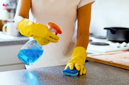 Office cleaners sanitising shared areas in a local Belsizepark office