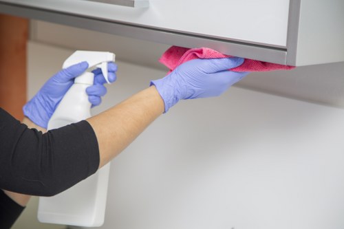 Cleaner preparing a kitchen in a Belsizepark home